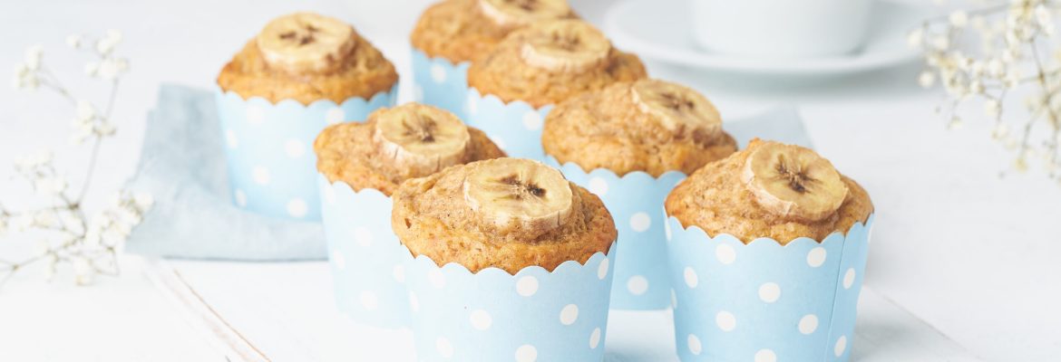 Banana muffin, cupcakes in a blue cake cases paper, white concrete table